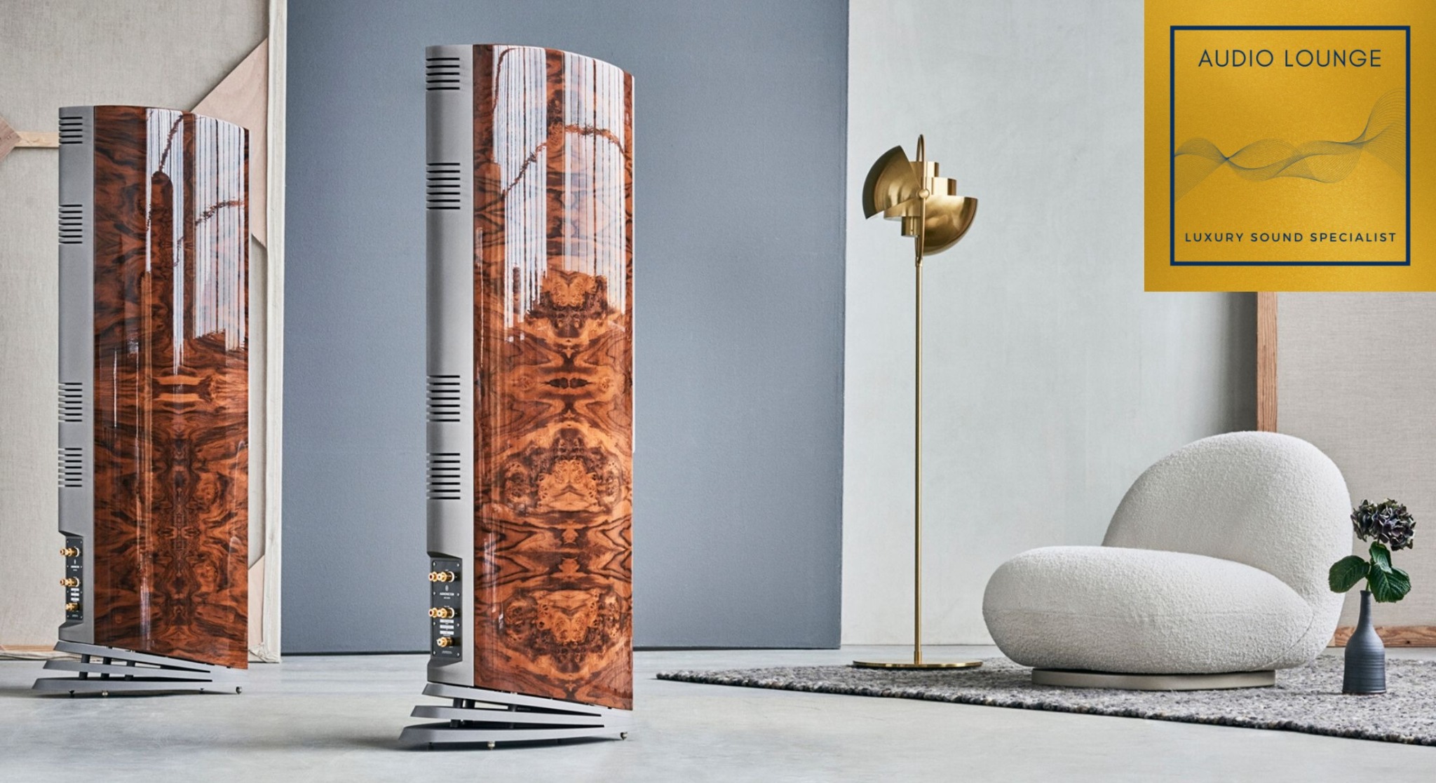 Floorstanding loudspeakers in a listening room with Audio Lounge branding