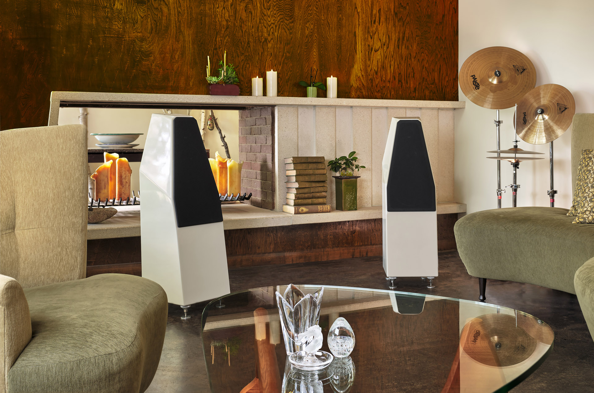 Wilson Audio SabrinaX loudspeakers in a furnished lounge with a dark wood backdrop